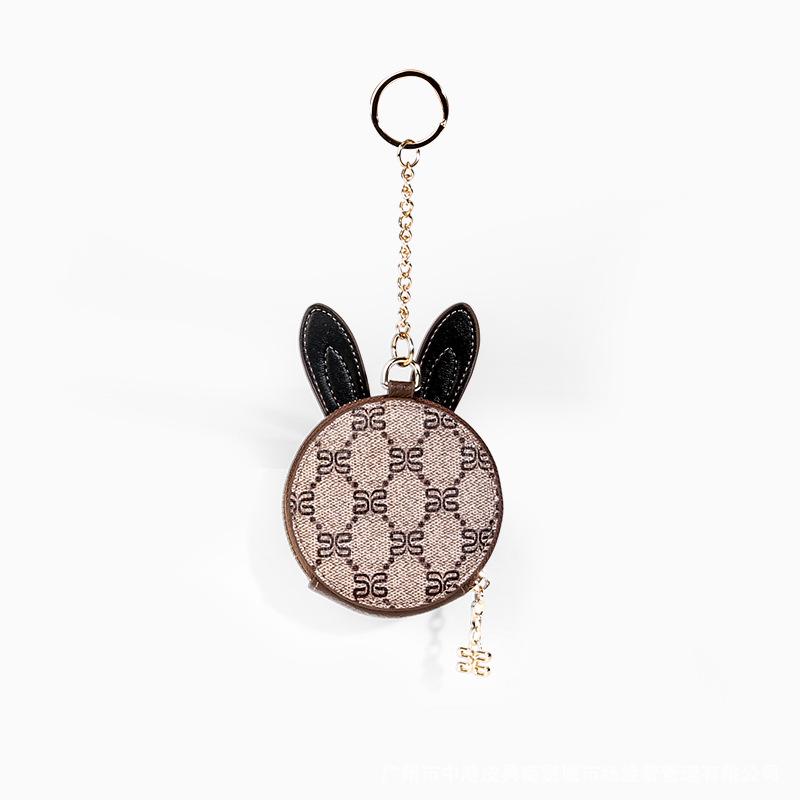 Cute mini cat purse coin bag for children made of genuine leather with gold fittings, perfect for storing coins and small items.