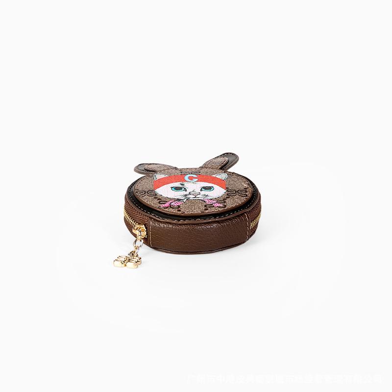 Cute mini cat purse coin bag for children made of genuine leather with gold fittings, perfect for storing coins and small items.