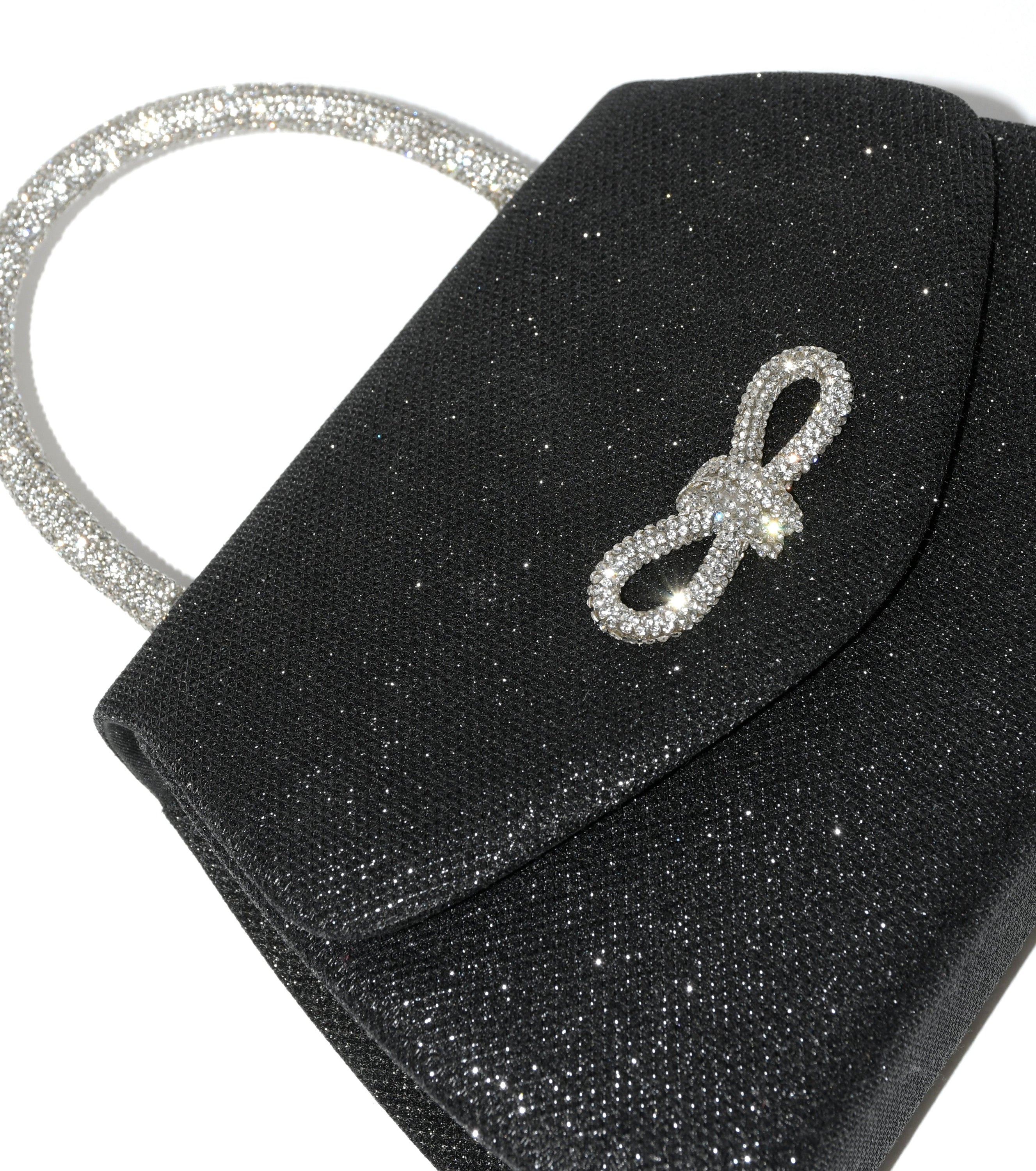 Elegant evening bag featuring a sparkling bow design and glitter handle, perfect for formal occasions.