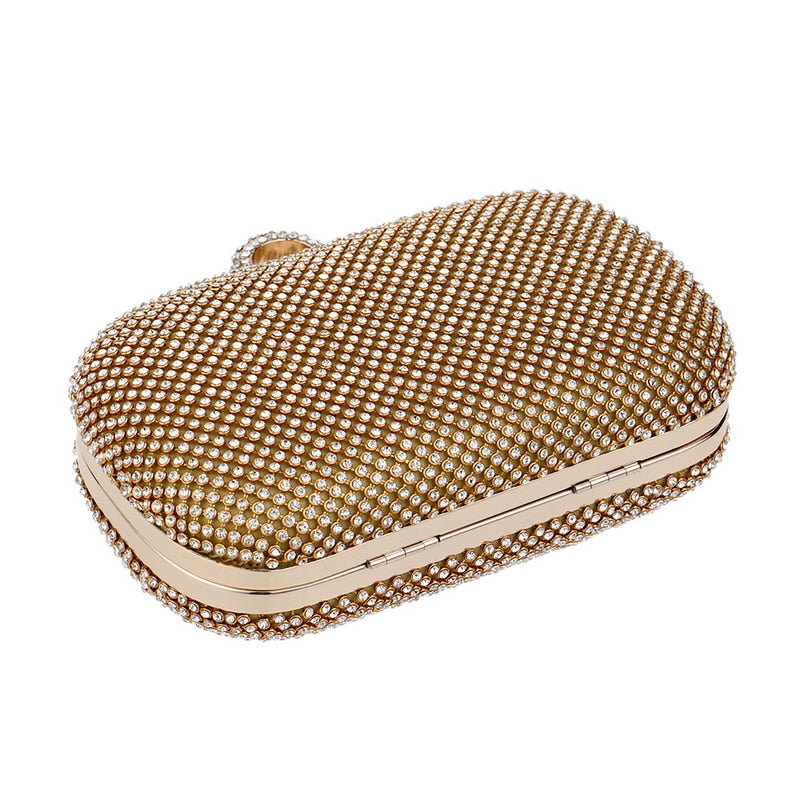 Elegant diamond-studded evening clutch bag with a chain shoulder strap, perfect for weddings and formal events.