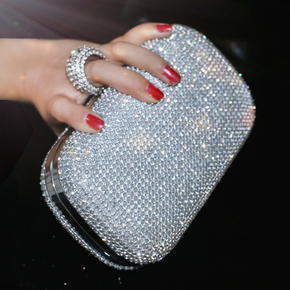 Elegant diamond-studded evening clutch bag with a chain shoulder strap, perfect for weddings and formal events.