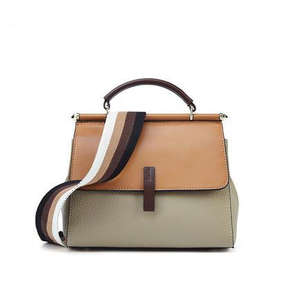 A stylish Female Fashion Color Contrast Shoulder Bag made from two-layer cowhide, featuring a shell shape, zipper buckle opening, and a wide shoulder strap.