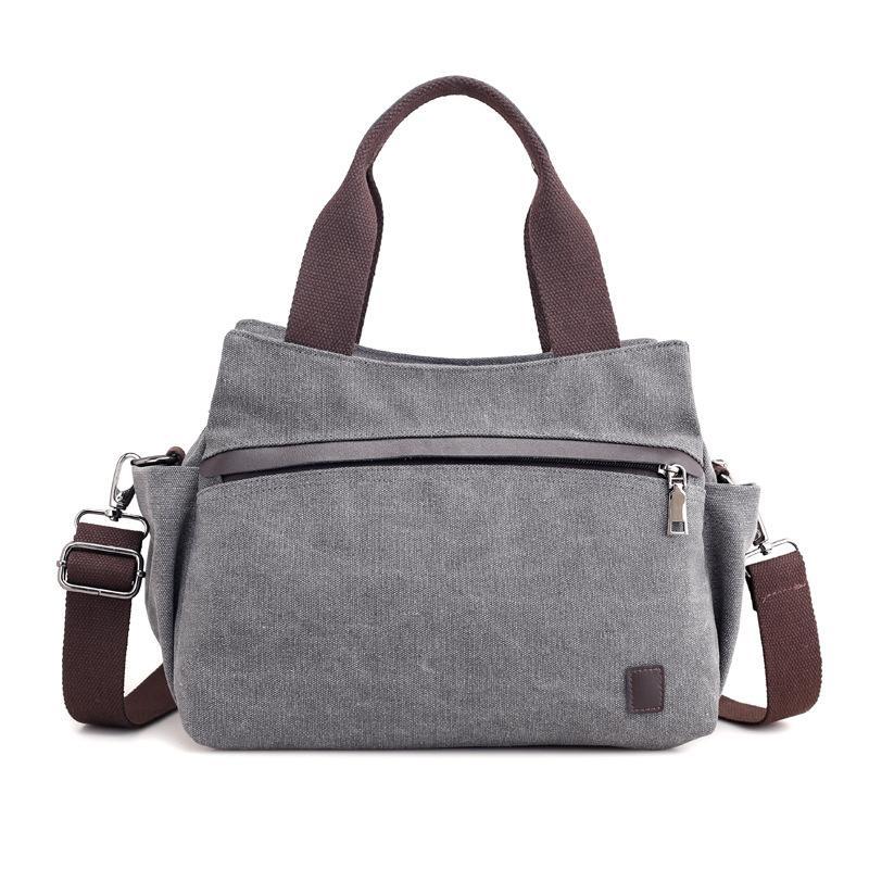 A stylish female fashion vintage canvas messenger bag with a durable polyester cotton lining, featuring an adjustable strap and a chic design.