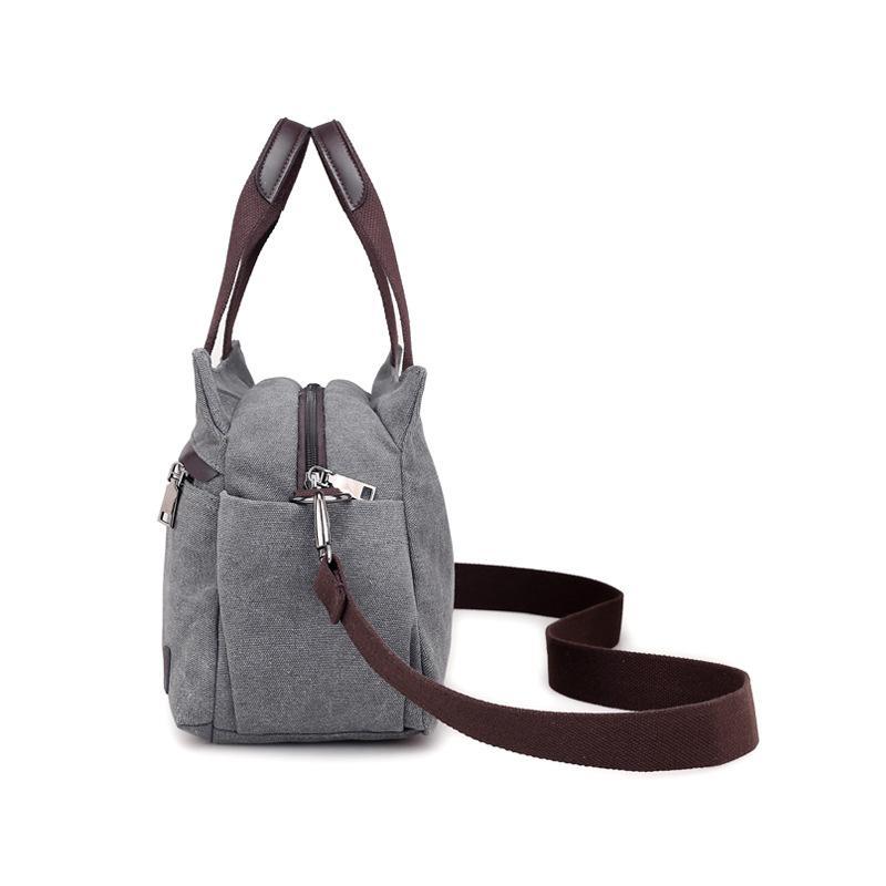 A stylish female fashion vintage canvas messenger bag with a durable polyester cotton lining, featuring an adjustable strap and a chic design.