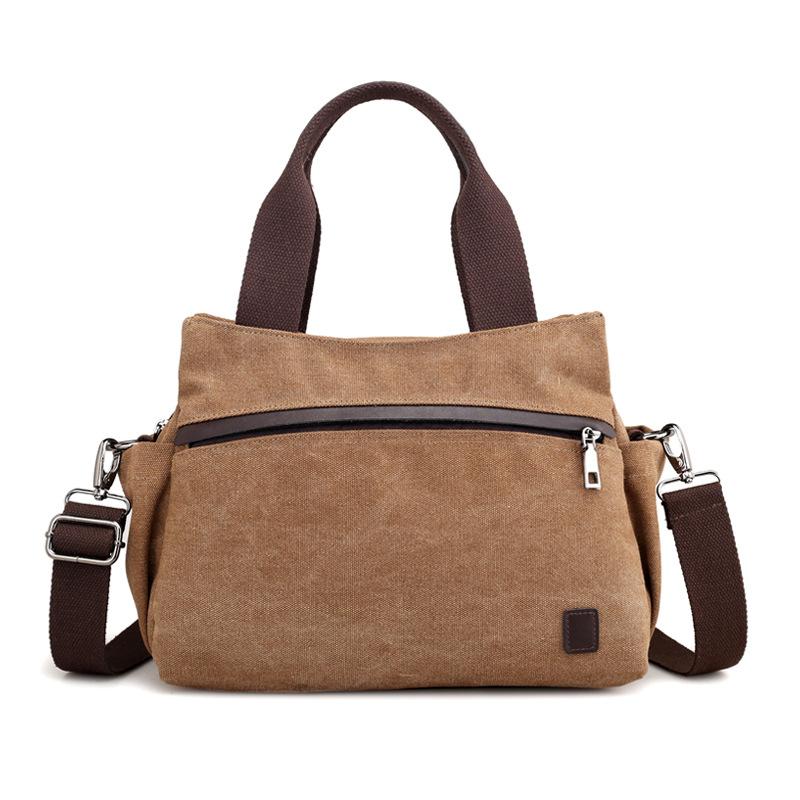 A stylish female fashion vintage canvas messenger bag with a durable polyester cotton lining, featuring an adjustable strap and a chic design.