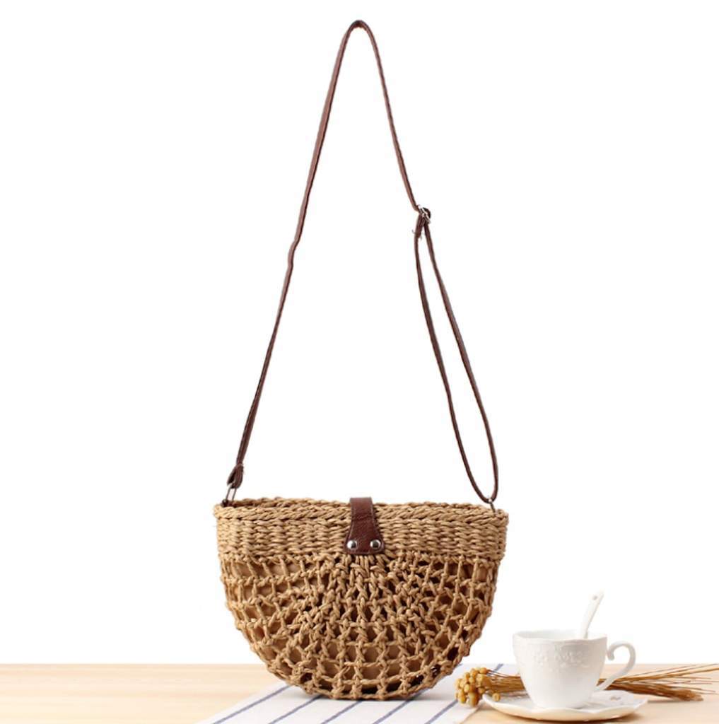 Half Moon Straw Crossbody Bag made of wicker straw with a vegan leather strap, featuring a trendy semi-circle design in brown color.