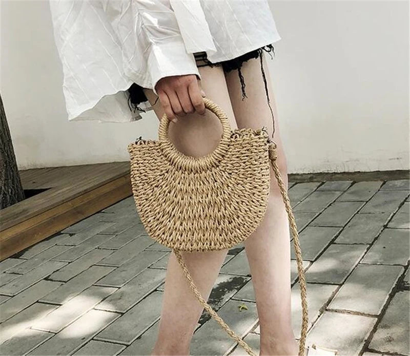 Handmade Half-Round Rattan Woven Straw Bag showcasing its unique half-moon shape and natural straw material, perfect for bohemian style.