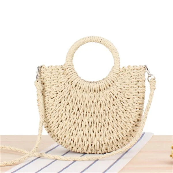 Handmade Half-Round Rattan Woven Straw Bag showcasing its unique half-moon shape and natural straw material, perfect for bohemian style.