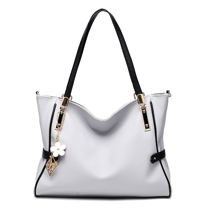 High Quality Large Capacity Handbag for Women in soft PU material, featuring a zipper closure and spacious interior with pockets for organization.