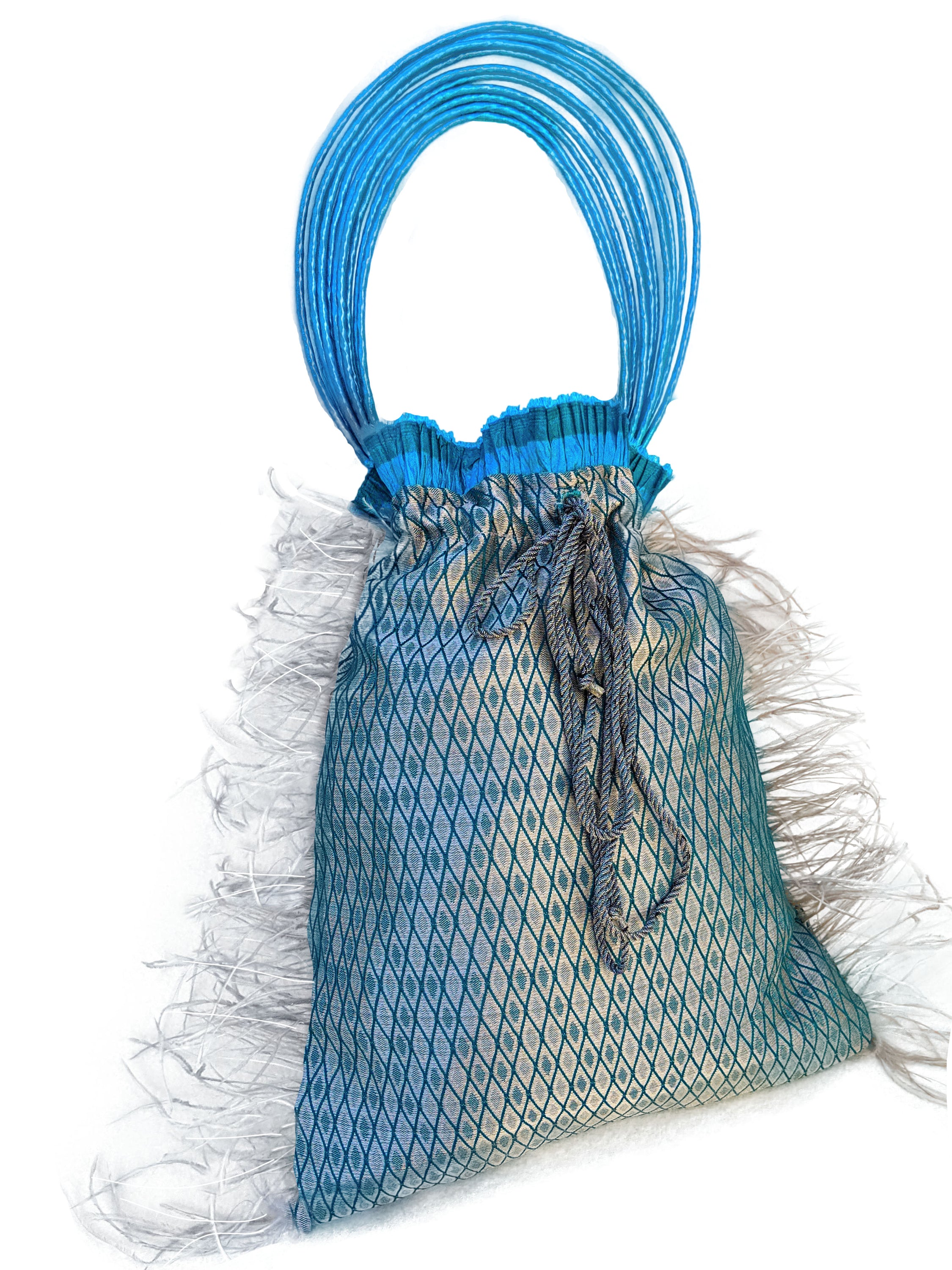 Imperial Jasper pouch bag featuring silvery blue fabric, turquoise accordion detail, grey feathers, and raffia cord handle.