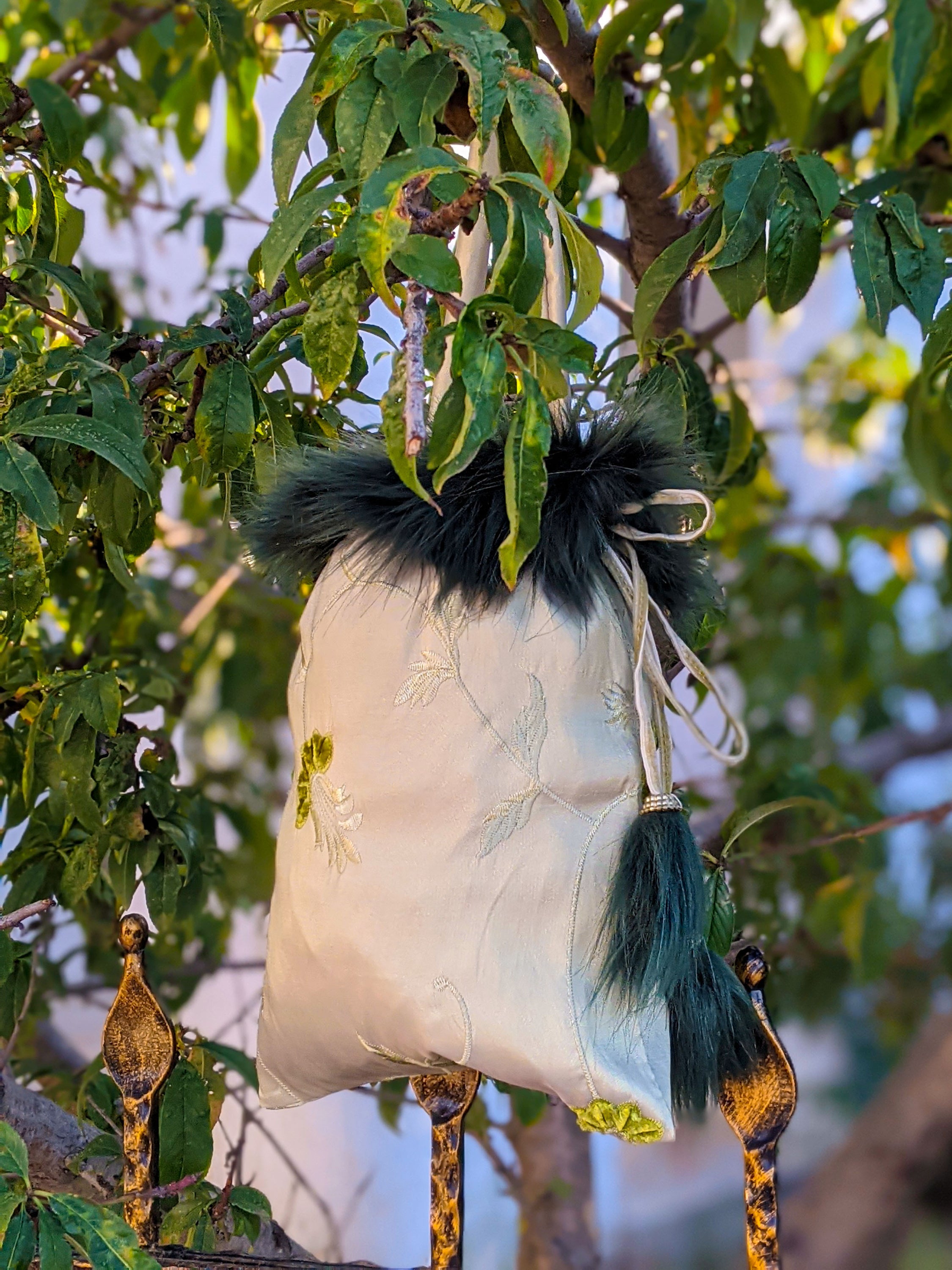 Kambaba Jasper pouch bag featuring dark green fur details and water green velvet string, elegantly designed with self-embossed taffeta.