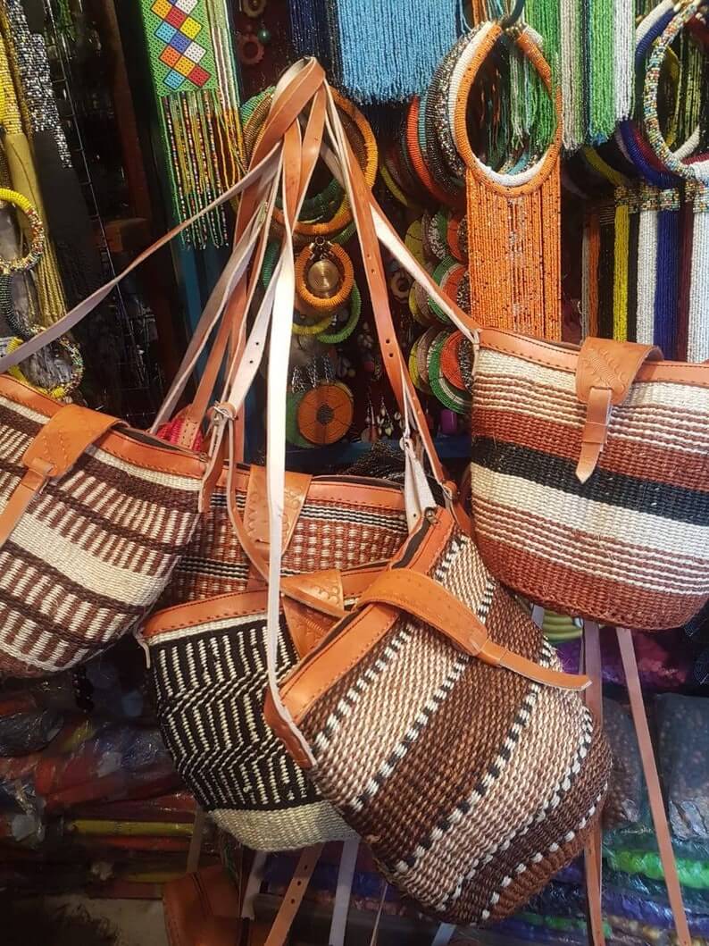 Kikuyu traditional handwoven African crossbody bag made from sisal and leather, featuring a zipper closure and cotton lining, showcasing unique patterns.