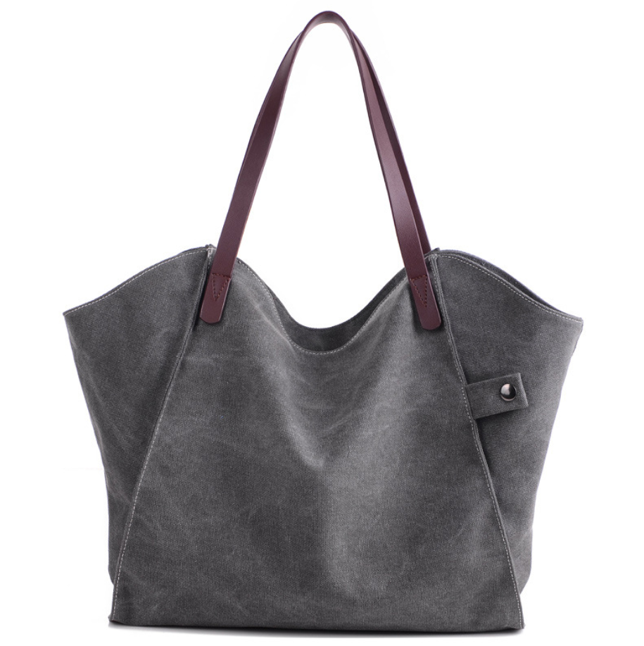 Large-capacity canvas shoulder bag for women, featuring a stylish design with soft handles and multiple pockets for organization.