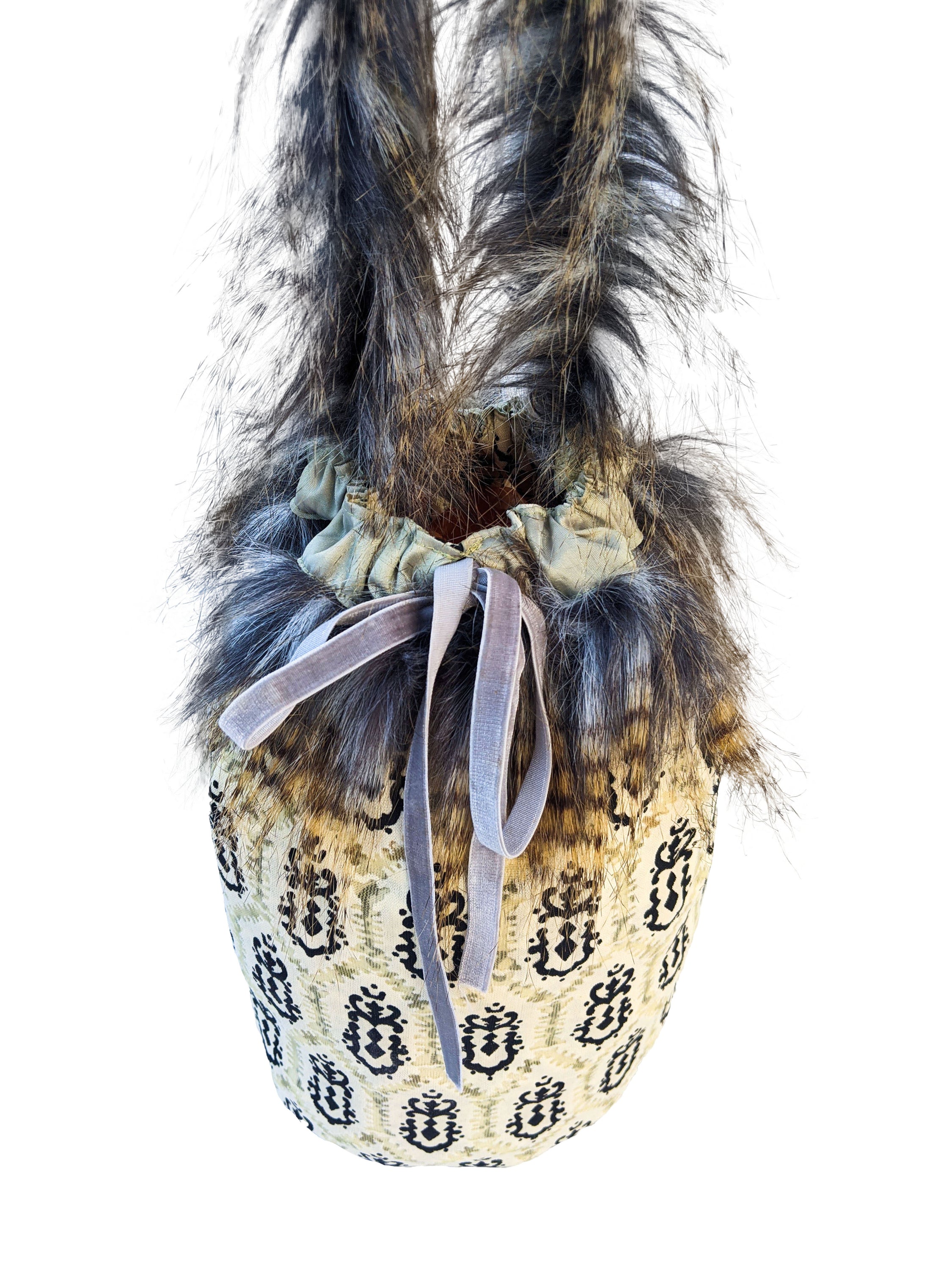 Leopard Skin Jasper pouch bag with faux fur handle and grey velvet elastic rope, showcasing its unique design and texture.