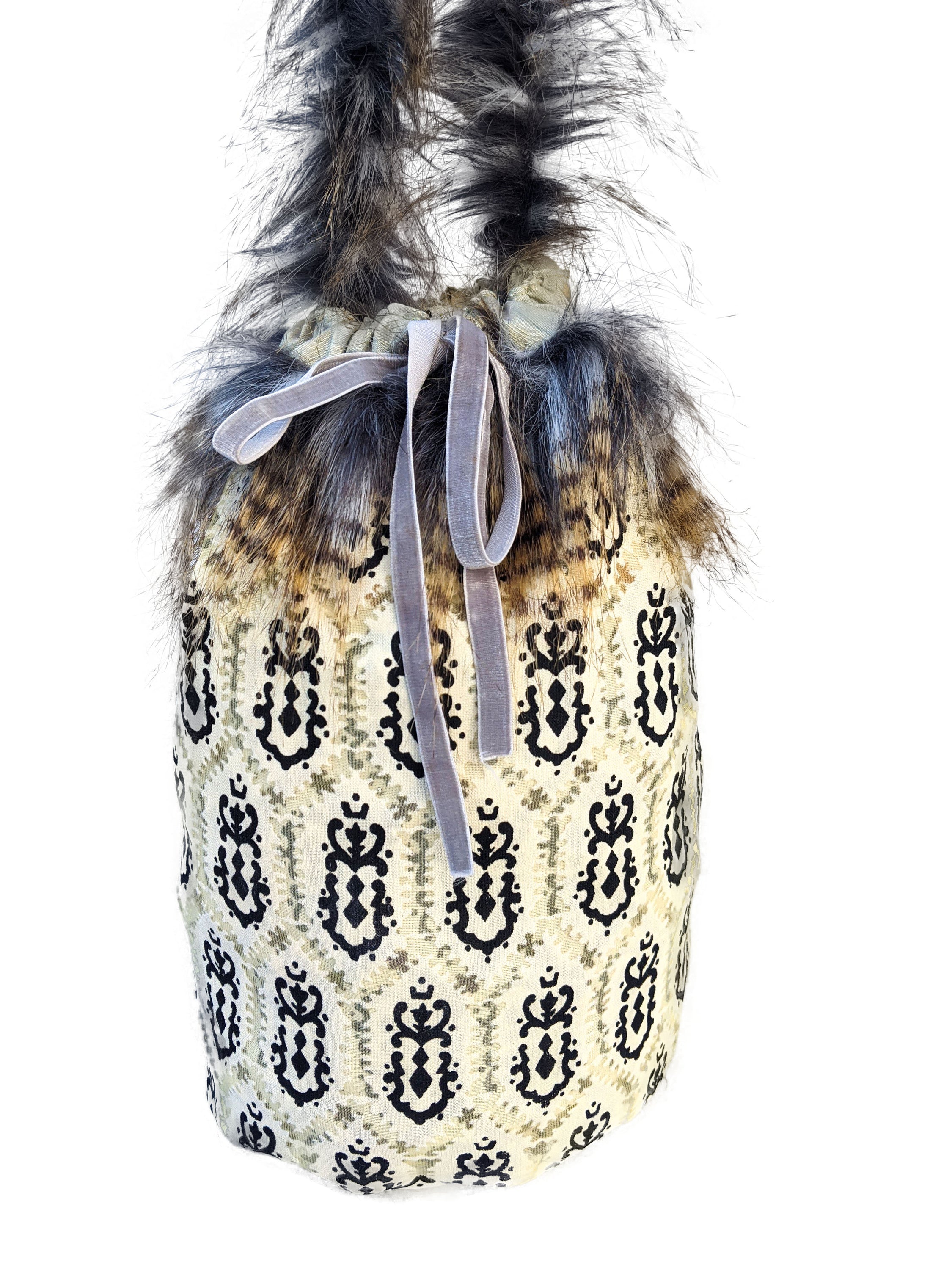 Leopard Skin Jasper pouch bag with faux fur handle and grey velvet elastic rope, showcasing its unique design and texture.