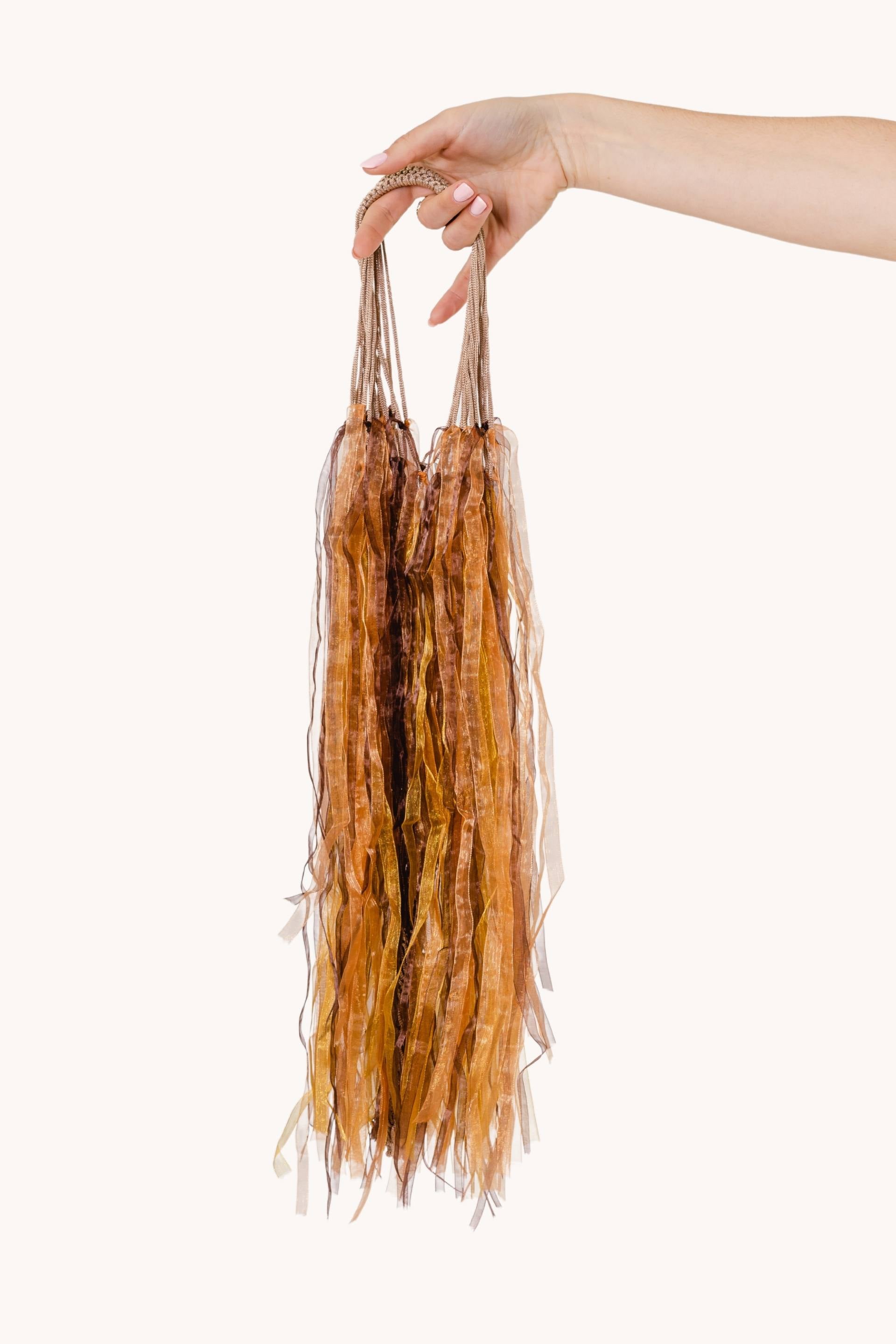 A stunning Lion's Mane Jellyfish showcasing its beige body and flowing orange-brown ribbons in the water.