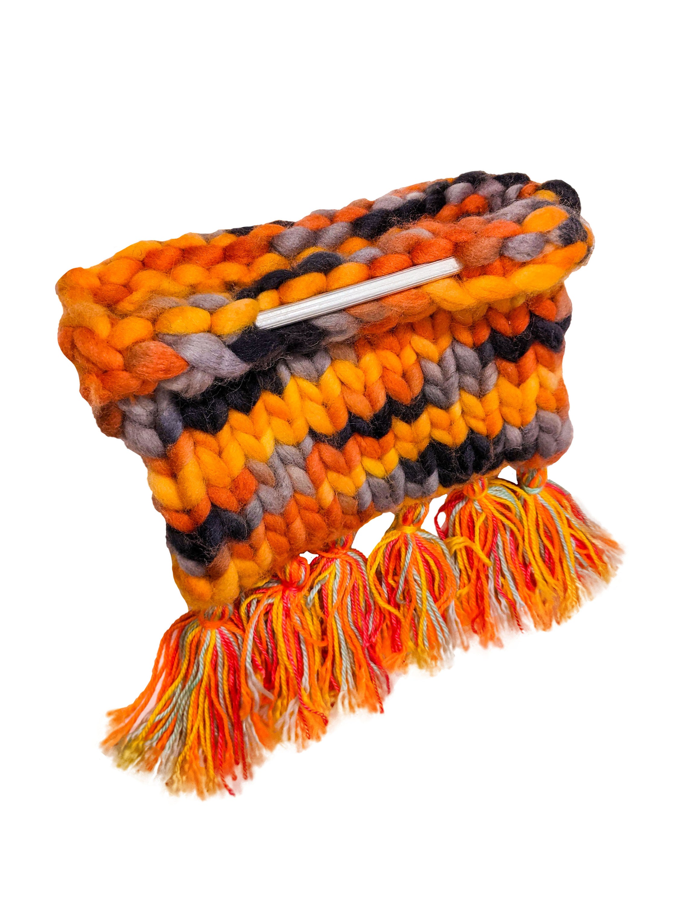 Morgan Hill Jasper knit pochette bag with fringes and wooden stick details, showcasing its unique handcrafted design.