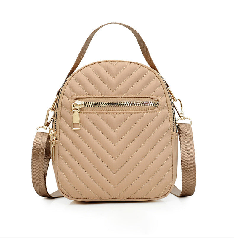 A stylish nylon quilted bag featuring multiple zipper pockets, adjustable strap, and gold-tone hardware.