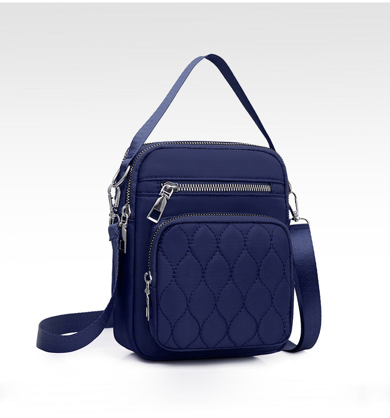 A stylish NYLON QUILTED BAG in black, featuring multiple zipper pockets and an adjustable strap, perfect for daily use.