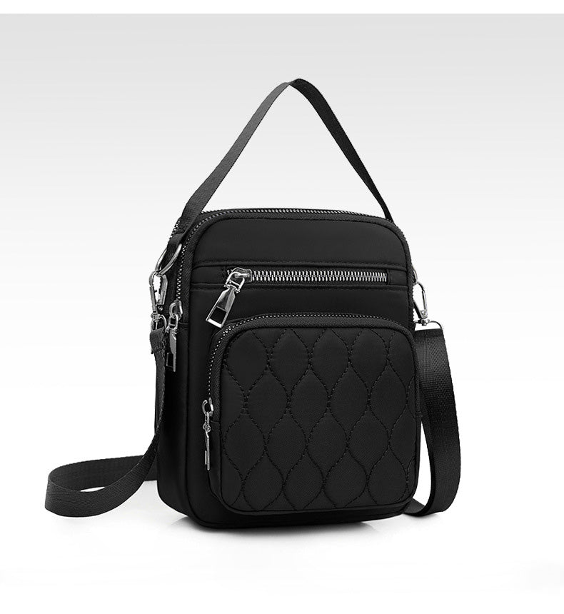 A stylish NYLON QUILTED BAG in black, featuring multiple zipper pockets and an adjustable strap, perfect for daily use.