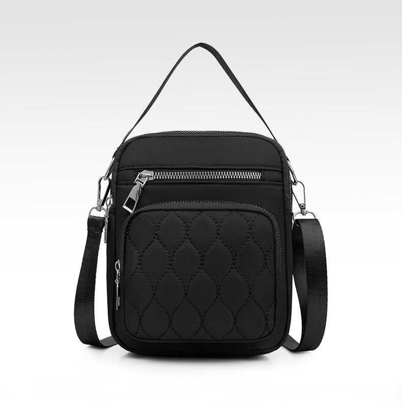 A stylish NYLON QUILTED BAG in black, featuring multiple zipper pockets and an adjustable strap, perfect for daily use.