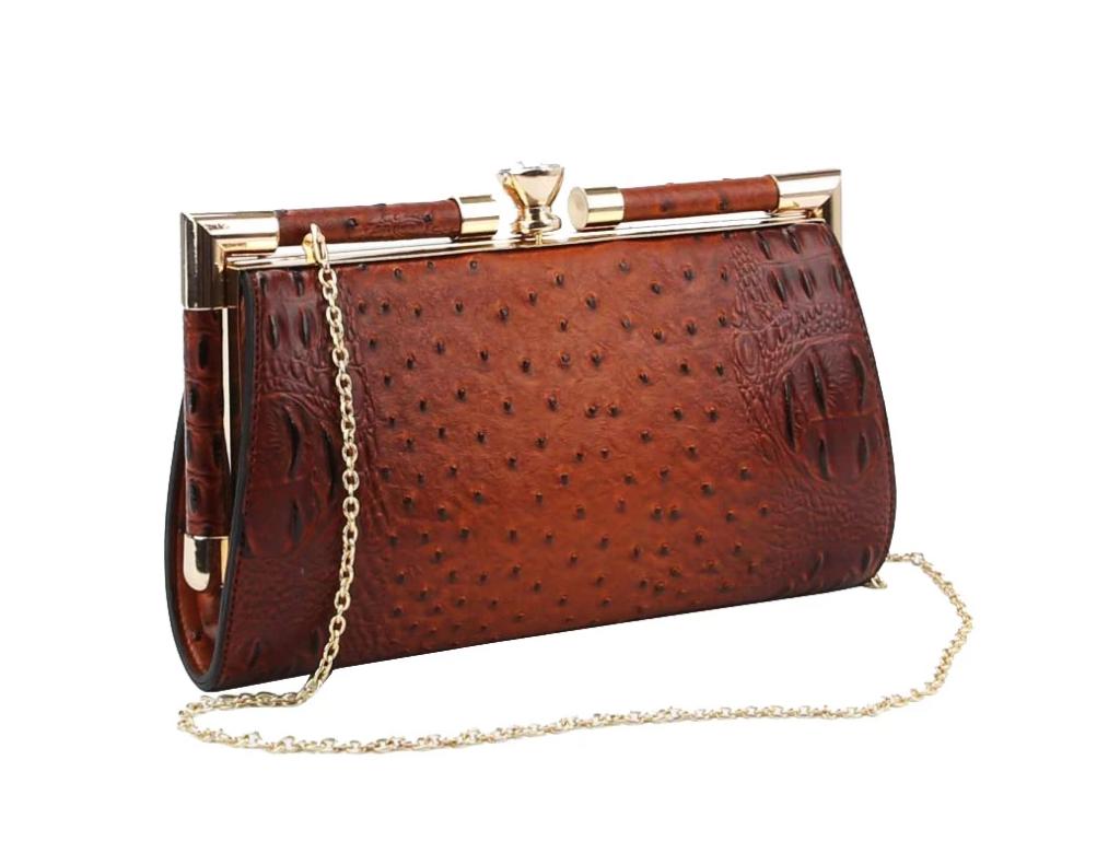 Ollie Clutch in brown faux leather with ostrich texture, featuring a jewel push tab closure and shoulder chain.