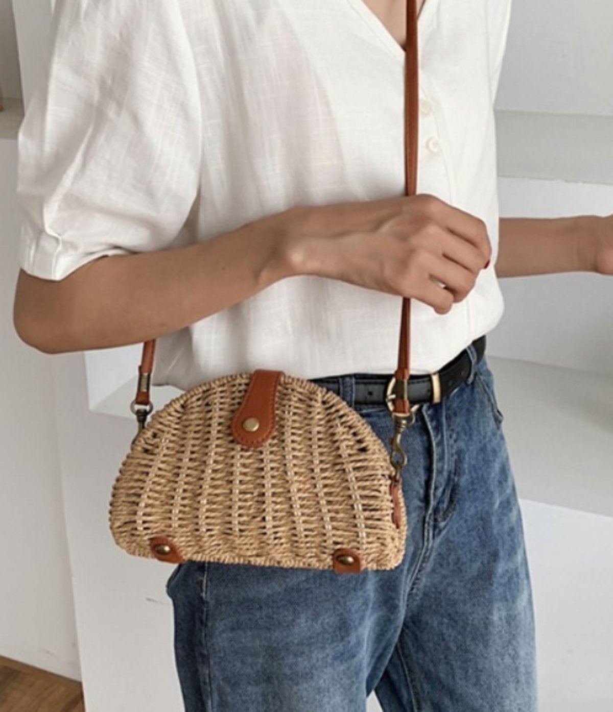 Oval Straw Small Crossbody Bag in khaki color, made from wicker straw, showcasing its stylish design and adjustable strap.