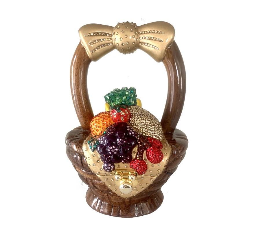 A beautifully hand-carved Acacia wood handbag designed as a fruit basket, adorned with sparkling Swarovski crystals, showcasing pineapples, grapes, and cherries.