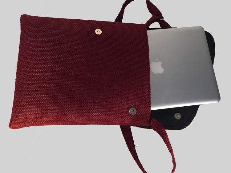 A vibrant maroon Shoulder Khanga Bag featuring traditional African Kitengi fabric flap and hessian woven body, ideal for laptops and daily essentials.