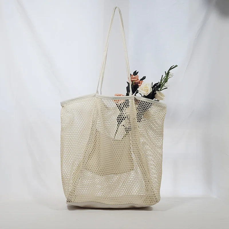 A large capacity hollow mesh tote bag in solid color, perfect for travel and beach outings, showcasing its lightweight and foldable design.