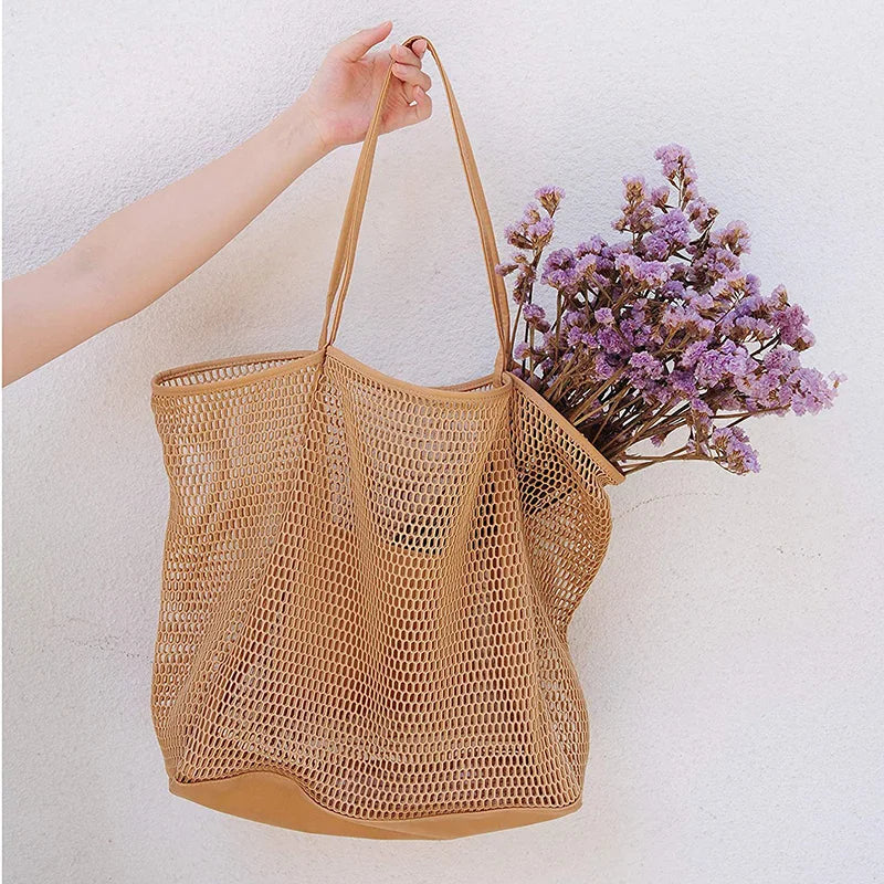 A large capacity hollow mesh tote bag in solid color, perfect for travel and beach outings, showcasing its lightweight and foldable design.