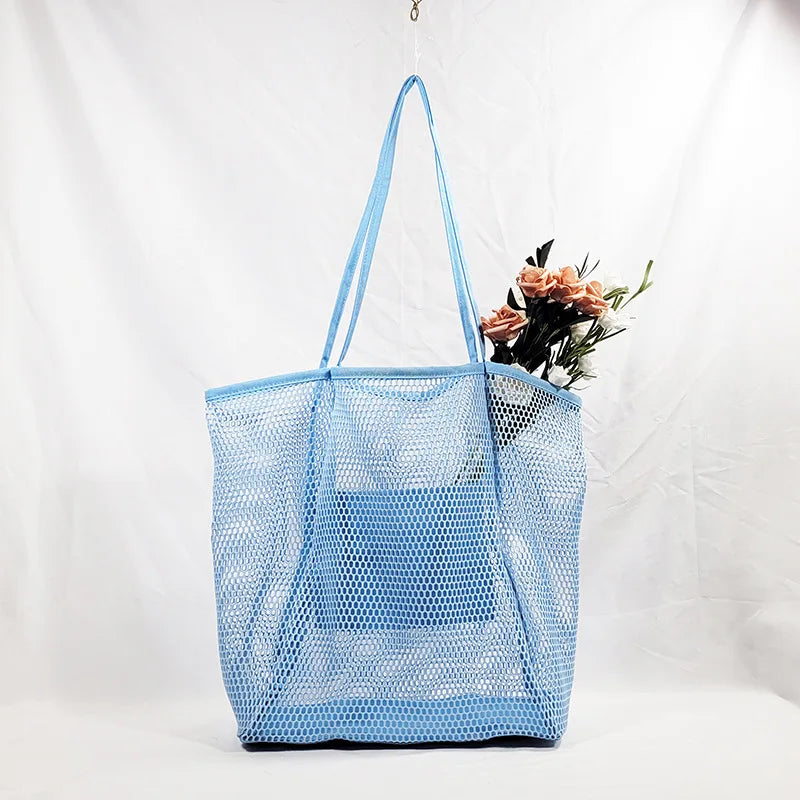 A large capacity hollow mesh tote bag in solid color, perfect for travel and beach outings, showcasing its lightweight and foldable design.