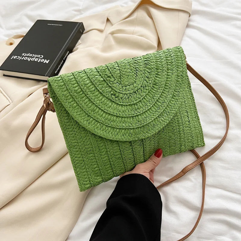 Stylish straw woven shoulder crossbody beach clutch bag for women, featuring a flap design and cell phone pocket.