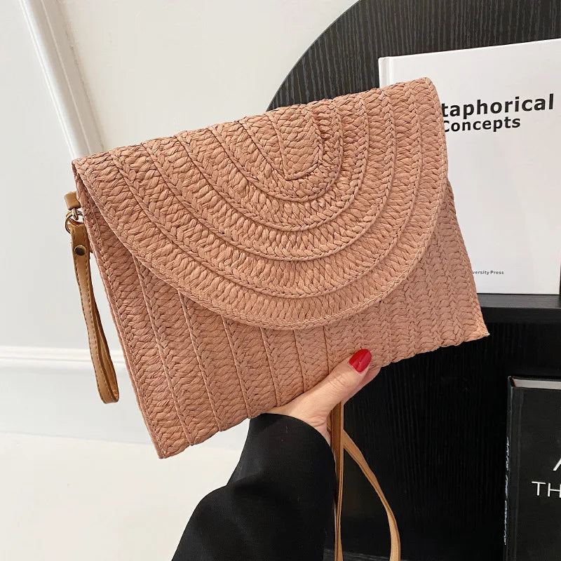 Stylish straw woven shoulder crossbody beach clutch bag for women, featuring a flap design and cell phone pocket.