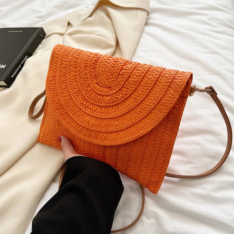 Stylish straw woven shoulder crossbody beach clutch bag for women, featuring a flap design and cell phone pocket.