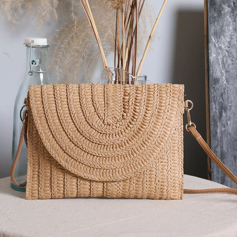 Stylish straw woven shoulder crossbody beach clutch bag for women, featuring a flap design and cell phone pocket.