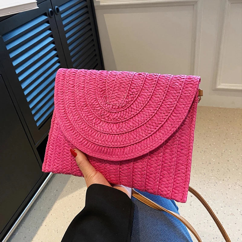 Stylish straw woven shoulder crossbody beach clutch bag for women, featuring a flap design and cell phone pocket.