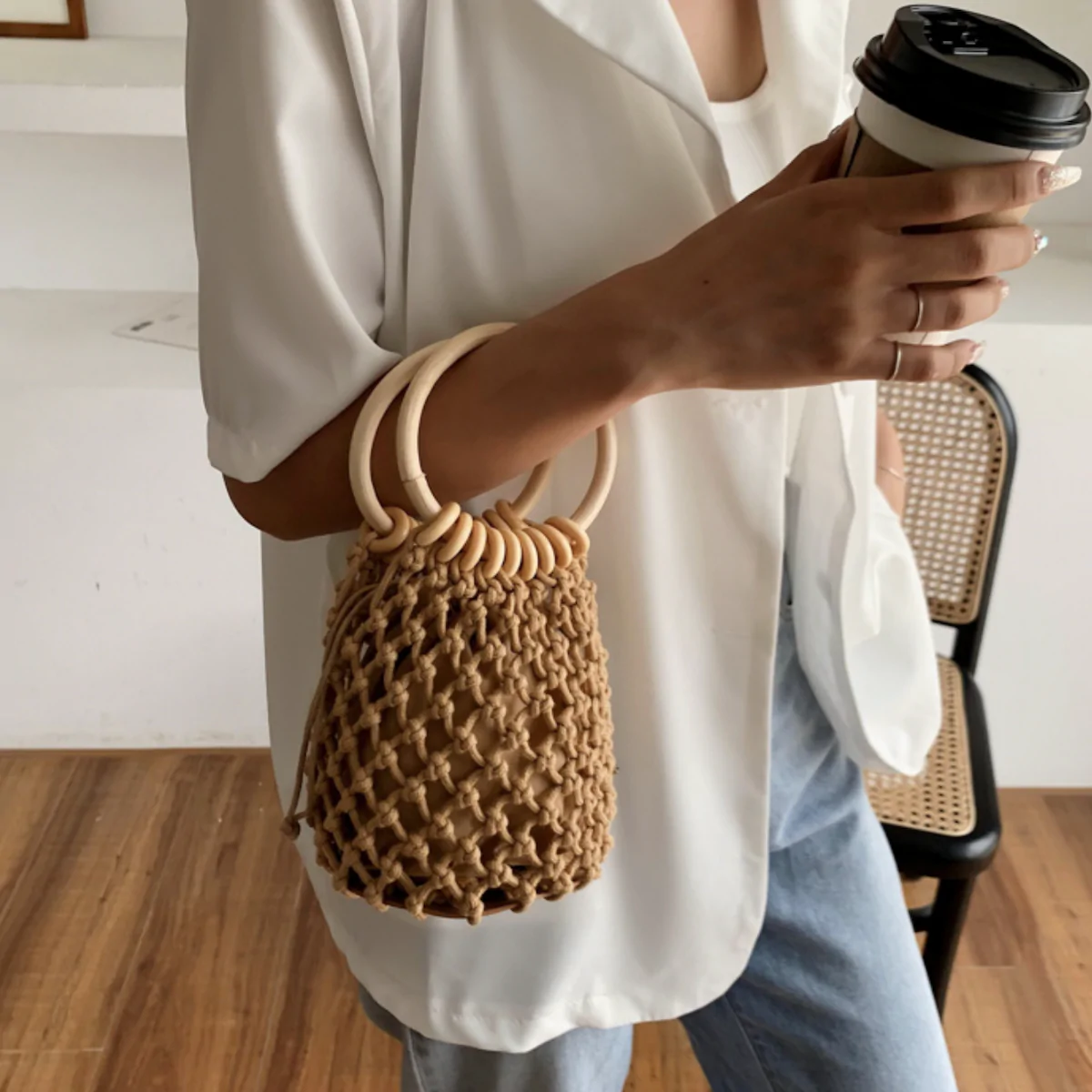 A stylish Summer Crochet Bag featuring a ratten ring handle, made from eco-friendly cotton rope and vegan leather, available in brown and off-white.