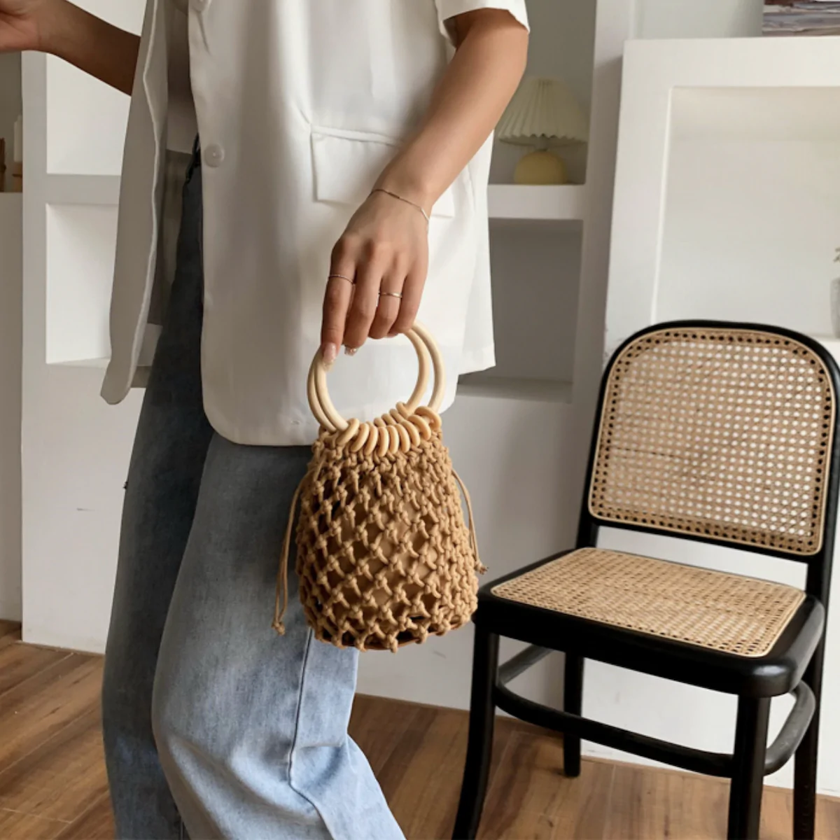 A stylish Summer Crochet Bag featuring a ratten ring handle, made from eco-friendly cotton rope and vegan leather, available in brown and off-white.