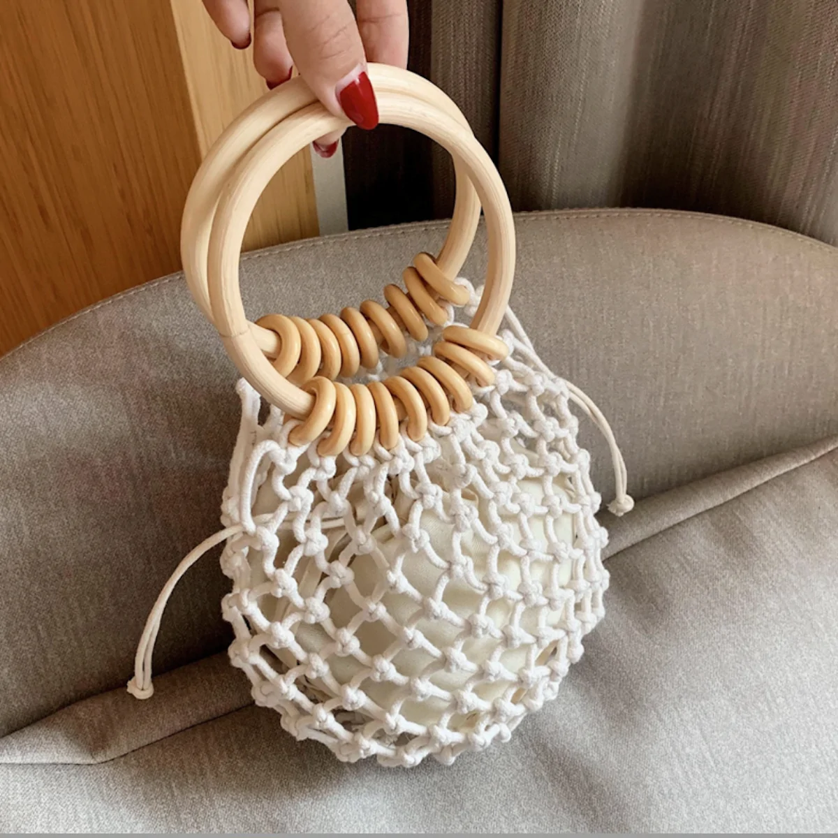 A stylish Summer Crochet Bag featuring a ratten ring handle, made from eco-friendly cotton rope and vegan leather, available in brown and off-white.