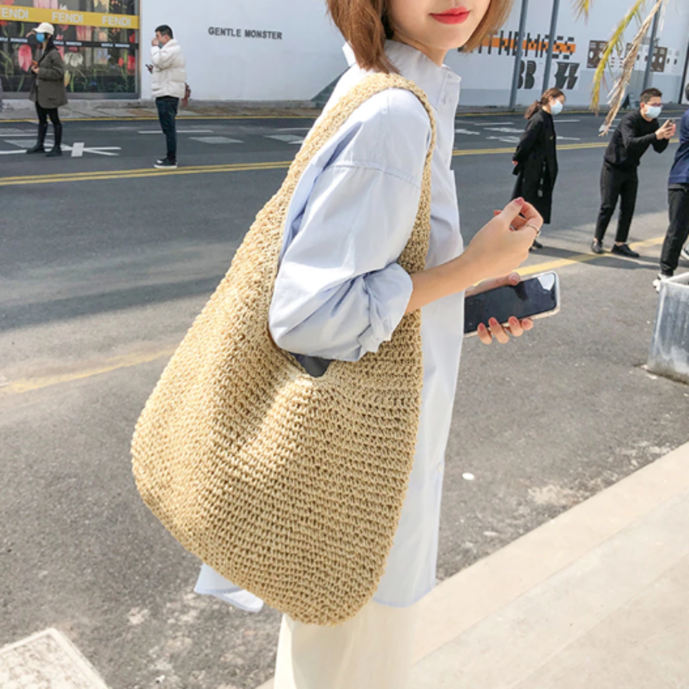 A stylish Summer Shoulder Straw Tote made of durable straw material, featuring a spacious interior and a trendy design, perfect for summer outings.