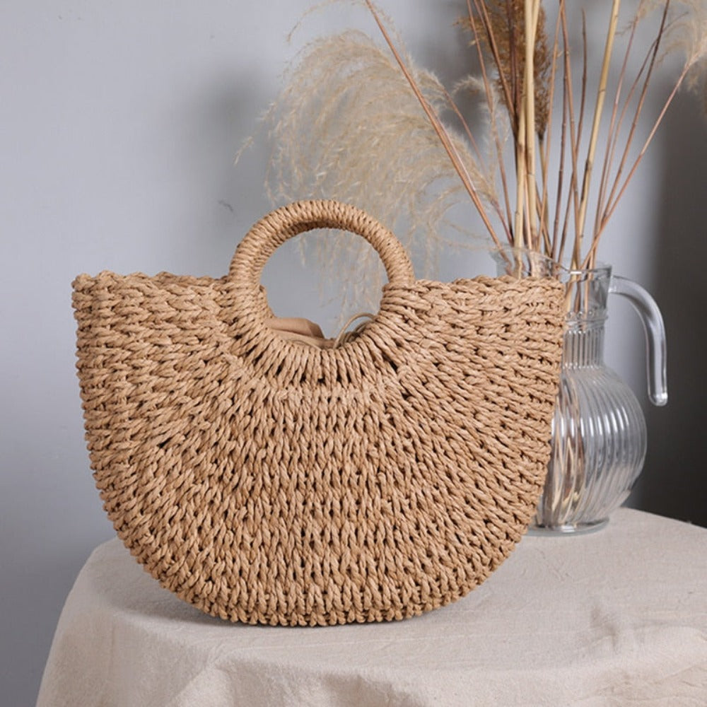 A stylish Summer Top Handle Semi Circle Straw Bag, showcasing its trendy semi-circle shape and lightweight straw material, perfect for summer outings.