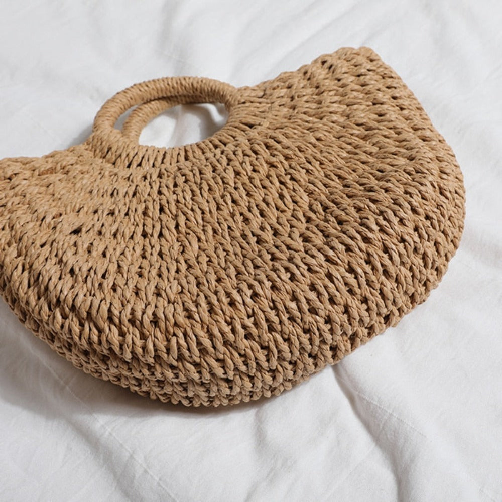 A stylish Summer Top Handle Semi Circle Straw Bag, showcasing its trendy semi-circle shape and lightweight straw material, perfect for summer outings.