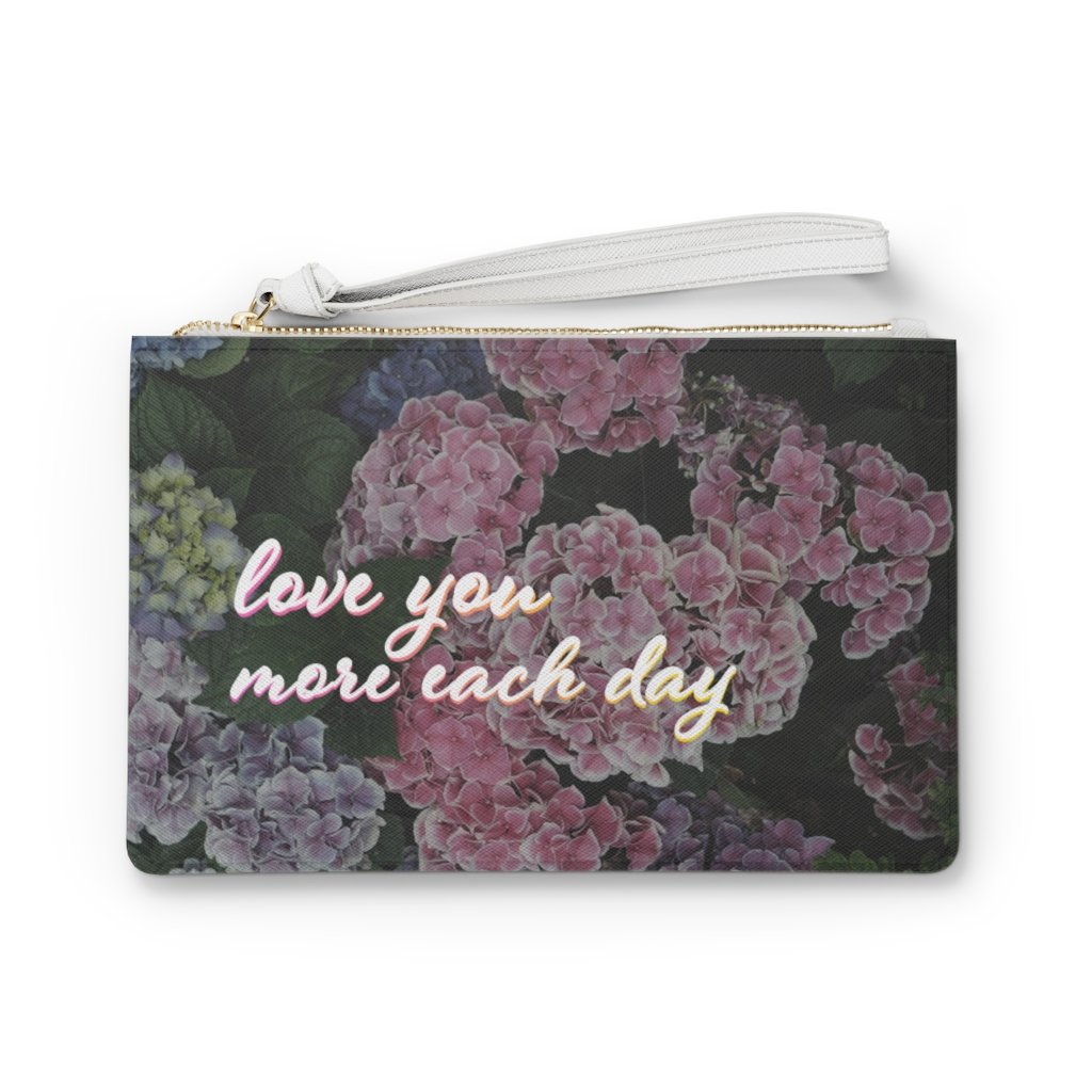 Sweet Floral Designed Zipped Clutch Bag made of vegan leather with a floral pattern and loop handle.