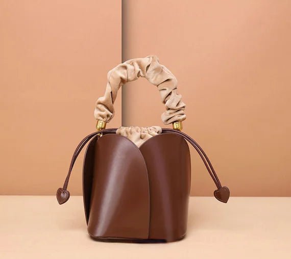 Tulip Leather Bucket bag featuring a unique four-bladed design and frilled handle, made from genuine leather.