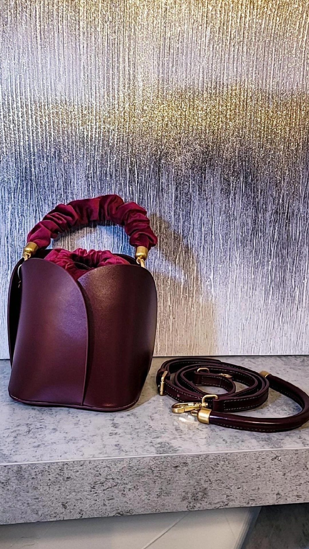 Tulip Leather Bucket bag featuring a unique four-bladed design and frilled handle, made from genuine leather.