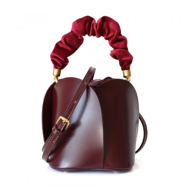 Tulip Leather Bucket bag featuring a unique four-bladed design and frilled handle, made from genuine leather.