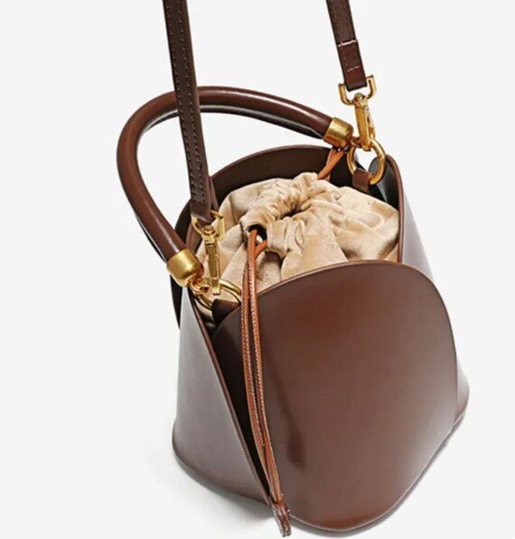 Tulip Leather Bucket bag featuring a unique four-bladed design and frilled handle, made from genuine leather.