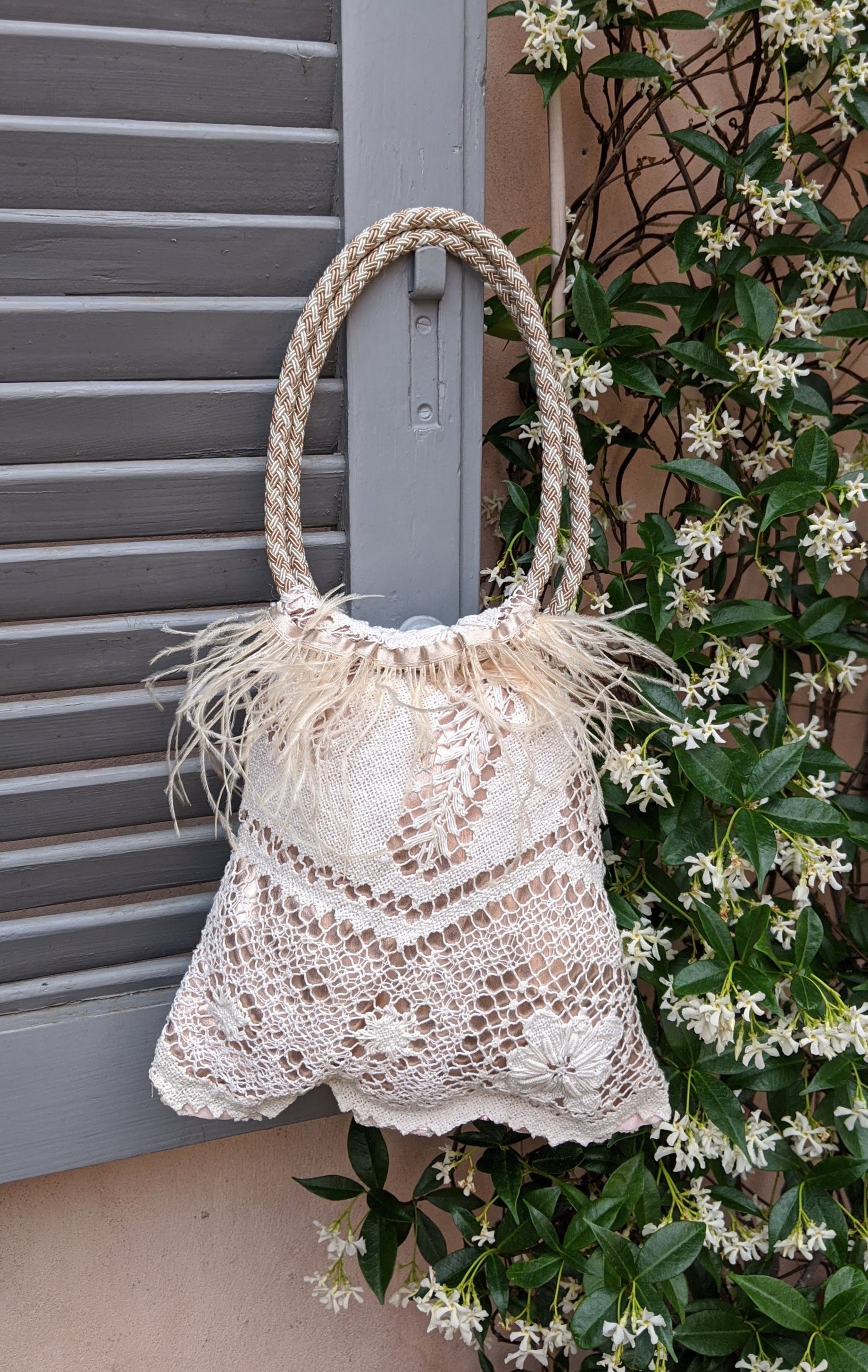 VENEZIANA Victorian Style lace handbag featuring intricate lace design, bronze-gold color, and cream feather decoration.