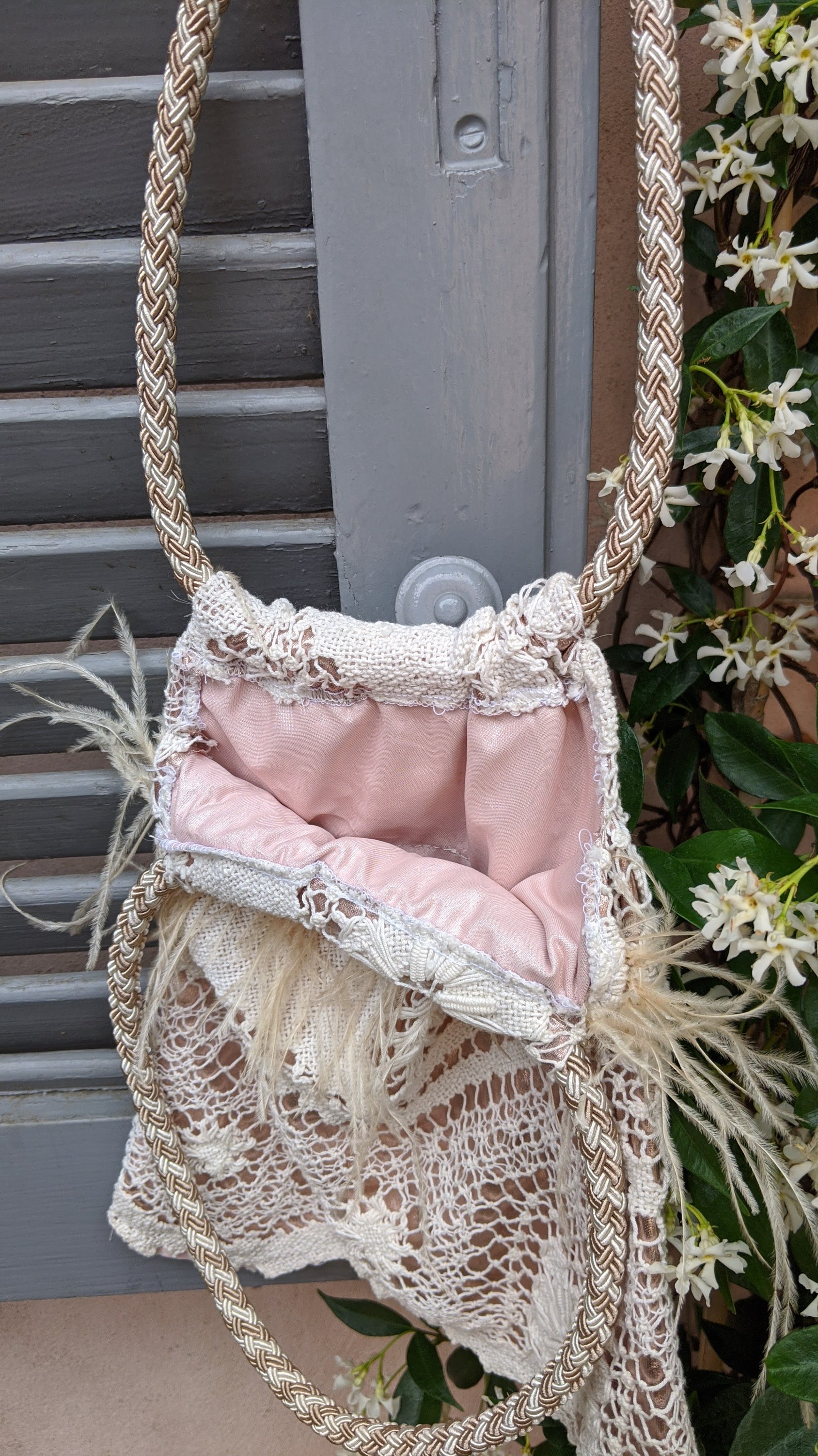 VENEZIANA Victorian Style lace handbag featuring intricate lace design, bronze-gold color, and cream feather decoration.